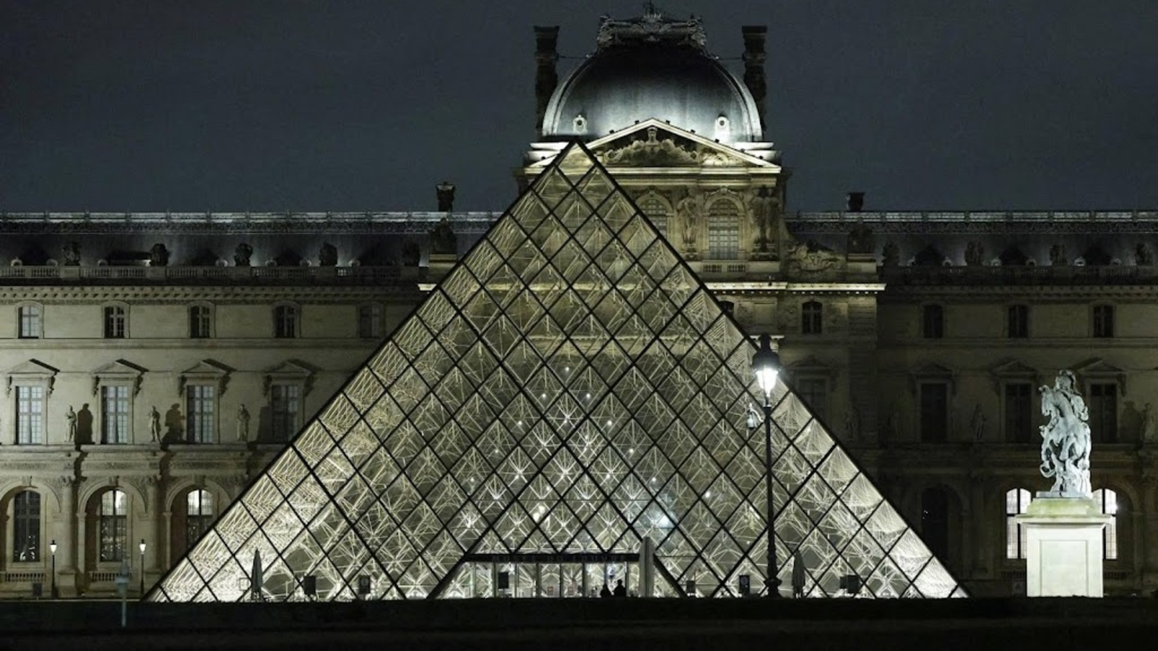 Activists hang photo of Andrew in Louvre after arrest